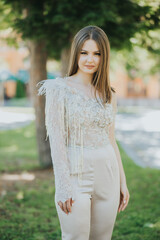 Wall Mural - Vertical shot of a Caucasian female with beautiful jumpsuit posing outdoors