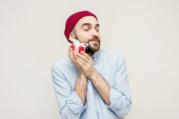 Wall Mural - Happy bearded man received a gift from his girlfriend on Valentine's Day, portrait, white background