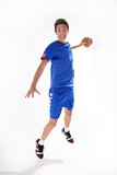 Full length photo of a young sporty boy throwing handball to the camera,