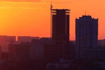 Dawn in Vladivostok. Silhouettes Two residential buildings under construction during a bright dawn.