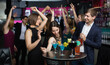 © JackF - Happy positive glad colleagues dancing on corporate party with cocktails in hands.