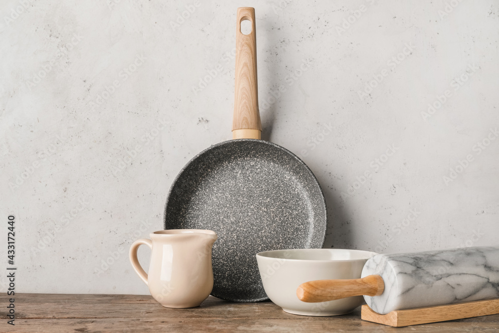 Set of kitchen utensils on light wooden background