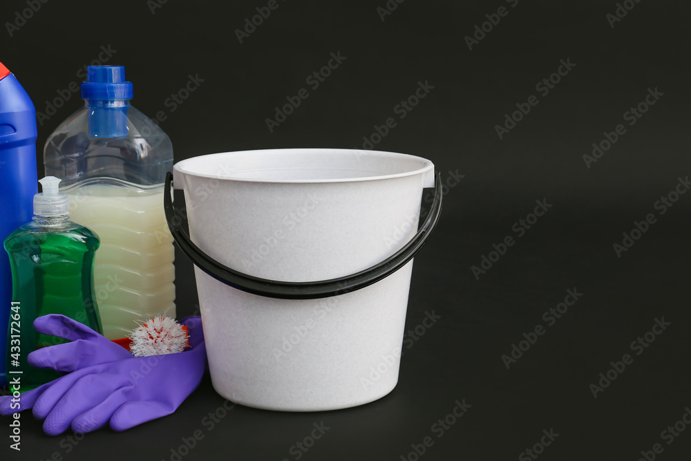 Set of cleaning supplies on dark background