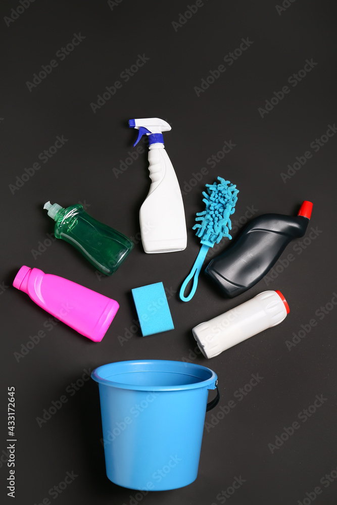 Set of cleaning supplies on dark background