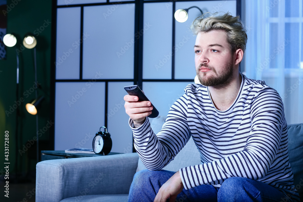 Young man watching TV at night. Concept of addiction