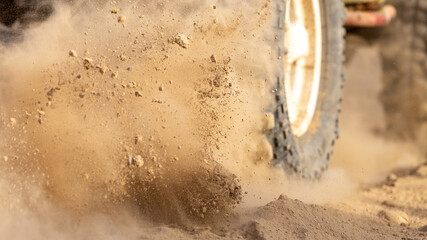 Motion the wheels tires off road dust cloud in desert, Offroad vehicle bashing through sand in the desert.