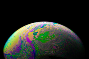 Wall Mural - Colourful bubbles. Abstract galaxy background with globe planet earth in universe space with sunlight on dark background. Abstract colorful soap bubble.