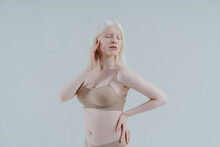 Beauty Image Of An Albino Girl Posing In Studio Wearing Lingerie. Concept About Body Positivity, Diversity, And Fashion