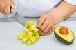 © JeanPaul - Avocado freshly cut into dice with a kitchen knife