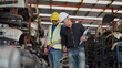 © iammotos - senior engineer using laptop computer checking list old used car engine with young asian worker in machinery parts shop warehouse. old manager find vehicle automobile machine in Recycle motor factory