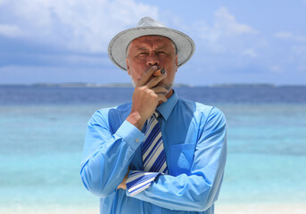 Wall Mural - man with a cigar on a tropical island