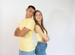 © Danko - Happy loving couple. Studio shot of beautiful young couple in casual clothes standing back to back and smiling