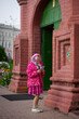 happy girl in purple dress, outdoor walks happy childhood selective focus, church of the Epiphany Yaroslavl Russia 03.08.2019