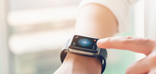 Close up of hand touching smartwatch with health app on the screen, gadget for fitness active lifestyle.