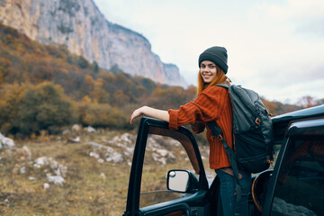 woman hiker near car in mountains trip travel adventure