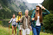 © NDABCREATIVITY - Group of friends on a hiking, camping trip in the mountains