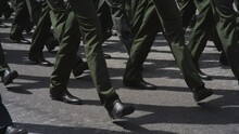 A Close-up Of The Feet Of Military Men Who March On The Parade . Same Clothes And Shoes In Public. Military March Close-up In Slowmotion Shooting.