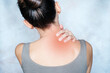 A woman massages her shoulder and neck pain points, trigger point massage, physiotherapy, and massage concept