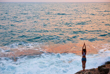 Yoga At Dawn. The Girl Meets The Sunrise At Sea. The Beginning Of The Day. Happy Morning. Sports, Healthy Lifestyle.