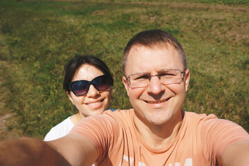 Wall Mural - couple making selfie on meadow