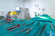 © Thirawatana - Operation room with surgical equipment. Knives, scissors, forceps, blood vessels and hospital equipment
