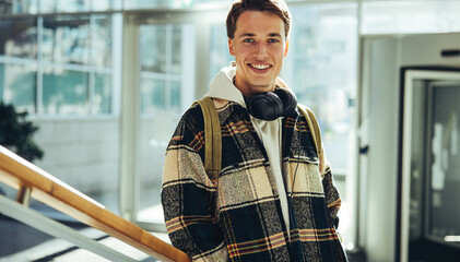 Wall Mural - Young man standing at college