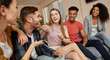 © Kostiantyn - Happy moments. Group of young happy multicultural people in casual wear enjoying time together while sitting on the sofa in the modern apartment