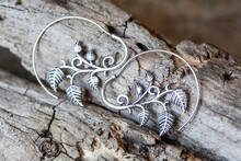 Silver Metal Decorative Oriental Spirale Design Earrings On Natural Neutral Background