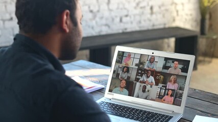 Wall Mural - Morning meeting on the distance. Back view over shoulder of hindu guy to the laptop screen with a lot of diverse people on it, work team brainstorming, discussing together, virtual meeting colleagues