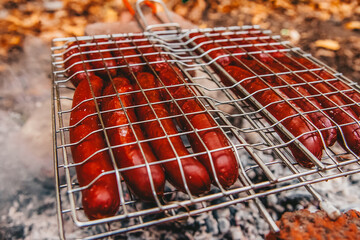 Sausages on fire on a portable barbecue