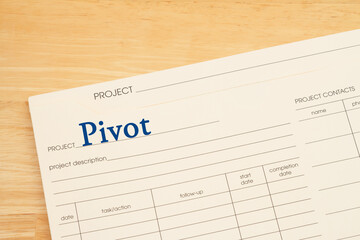 Wall Mural - Pivot project plan folder on a wood desk