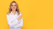 happy blonde businesswoman woman in white shirt pointing finger on copy space, advertisement