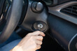 © sutlafk - Closeup inside vehicle of hand holding key in ignition, start engine key,     woman driver starting the car engine,  the concept of buying a used car or a rental car.