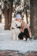 © Татьяна Добрикова - Pretty young woman walking and playing with samoyed dog on snowy winter morning.