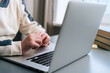 © dikushin - close-up hands unrecognizable child boy typing text using keyboard laptop sitting at desk with near window. Concept of distance education at home, closeup