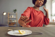 © Studio Romantic - No more drastic diet. Annoyed hungry lady pushes tiny apple piece away. Young woman dislikes food restriction, hates extreme dieting and quits. Bad negative attitude, International No Diet Day concept