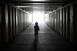 © penyushkin - The child goes from darkness to light. Dangerous walks through the dark tunnel