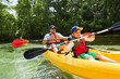 © Stefanie Aumiller/Westend61 - Boy with father in life jacket canoeing with oar in lake during picnic