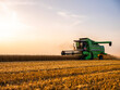 © oticki/Westend61 - Combine harvesting field of wheat at sunrise