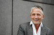 © Sandro J√∂dicke/Westend61 - Happy male expertise in front of gray wall
