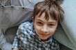 © Oxana Guryanova/Westend61 - Smiling boy lying on mother's lap at home