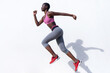 © Rafael Fernandez Torres/Westend61 - Female runner jumping while practicing against white wall