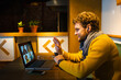 © Vasily Pindyurin/Westend61 - Male owner waving during video call on laptop while sitting at cafe