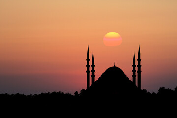 mosque silhouette in front of sunset background. Front view