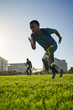 © Trevor Adeline/Caia Image - Focused male amputee sprinter training in sunny sports field