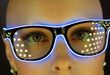 © Tom Merton/Caia Image - Close up portrait fashionable woman in futuristic neon eyeglasses