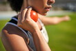 © Trevor Adeline/Caia Image - Close up female track and field athlete preparing to throw shot put