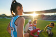 © Trevor Adeline/Caia Image - Female track and field athletes resting in stadium grass