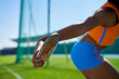 © Trevor Adeline/Caia Image - Close up female track and field athlete throwing discus