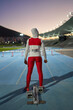 © Trevor Adeline/Caia Image - Female track and field athlete in hijab at starting block on track